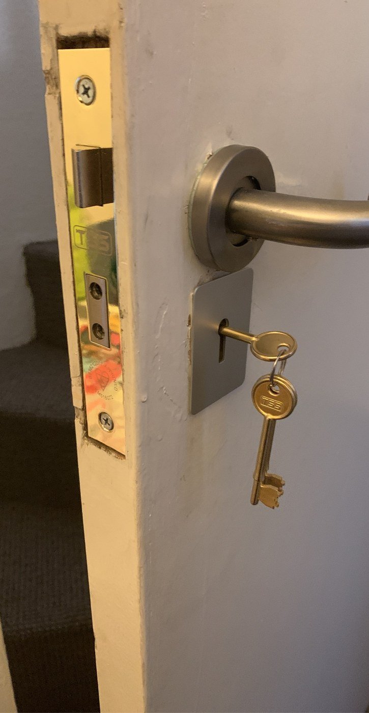 Locksmith repairing a multi-point uPVC door lock in Pimlico